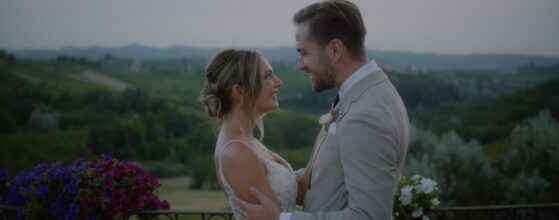 Bride and groom holding each other on the terrace of La Villa Hotel in Piemonte, Italy, with vineyards in the background – scene from their destination wedding film. Piemonte Italy wedding videographer