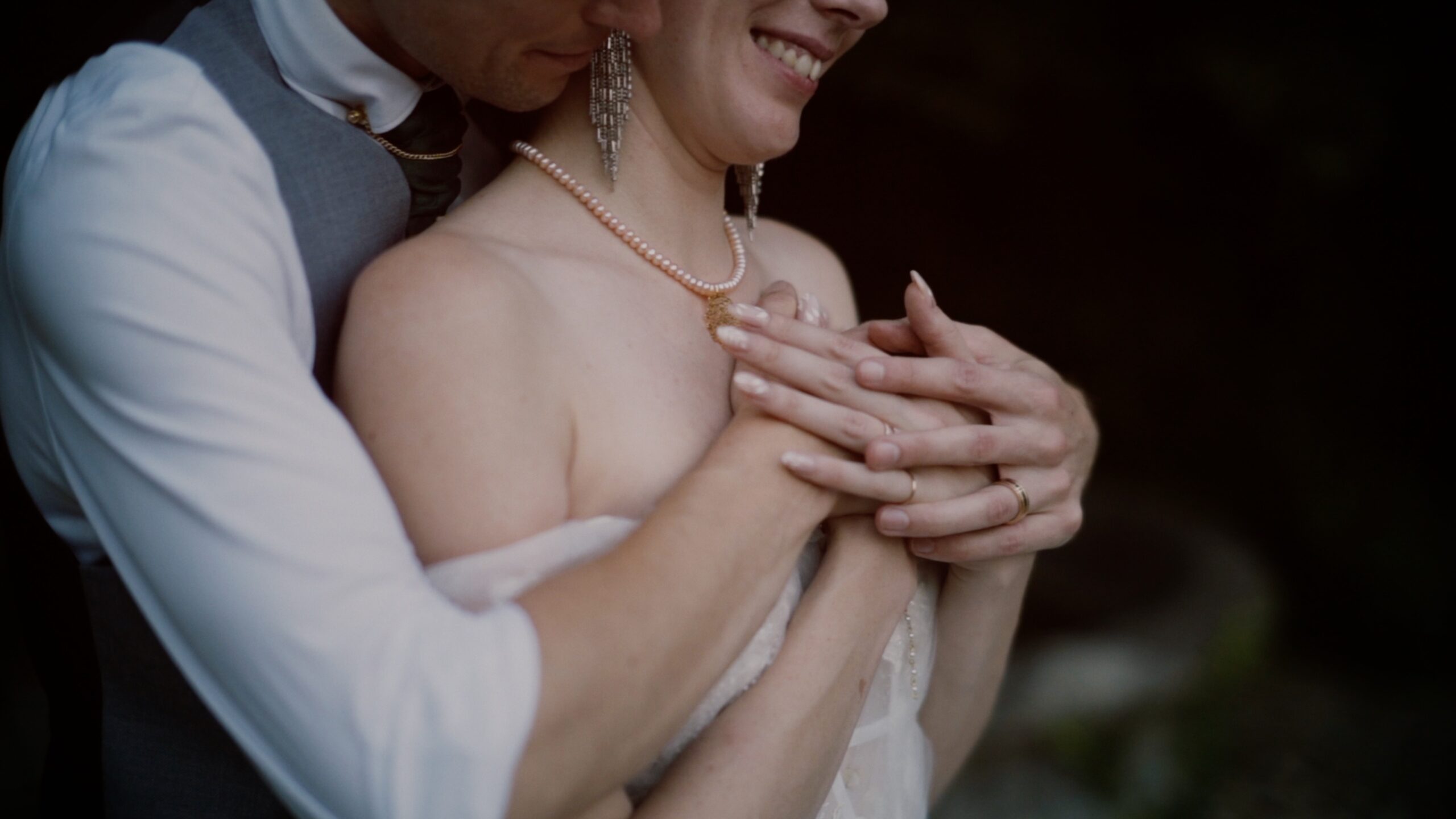 Lana and David sitting together in a wooden boat on the lake at Schloss Obermayerhofen during their romantic wedding day in Austria.