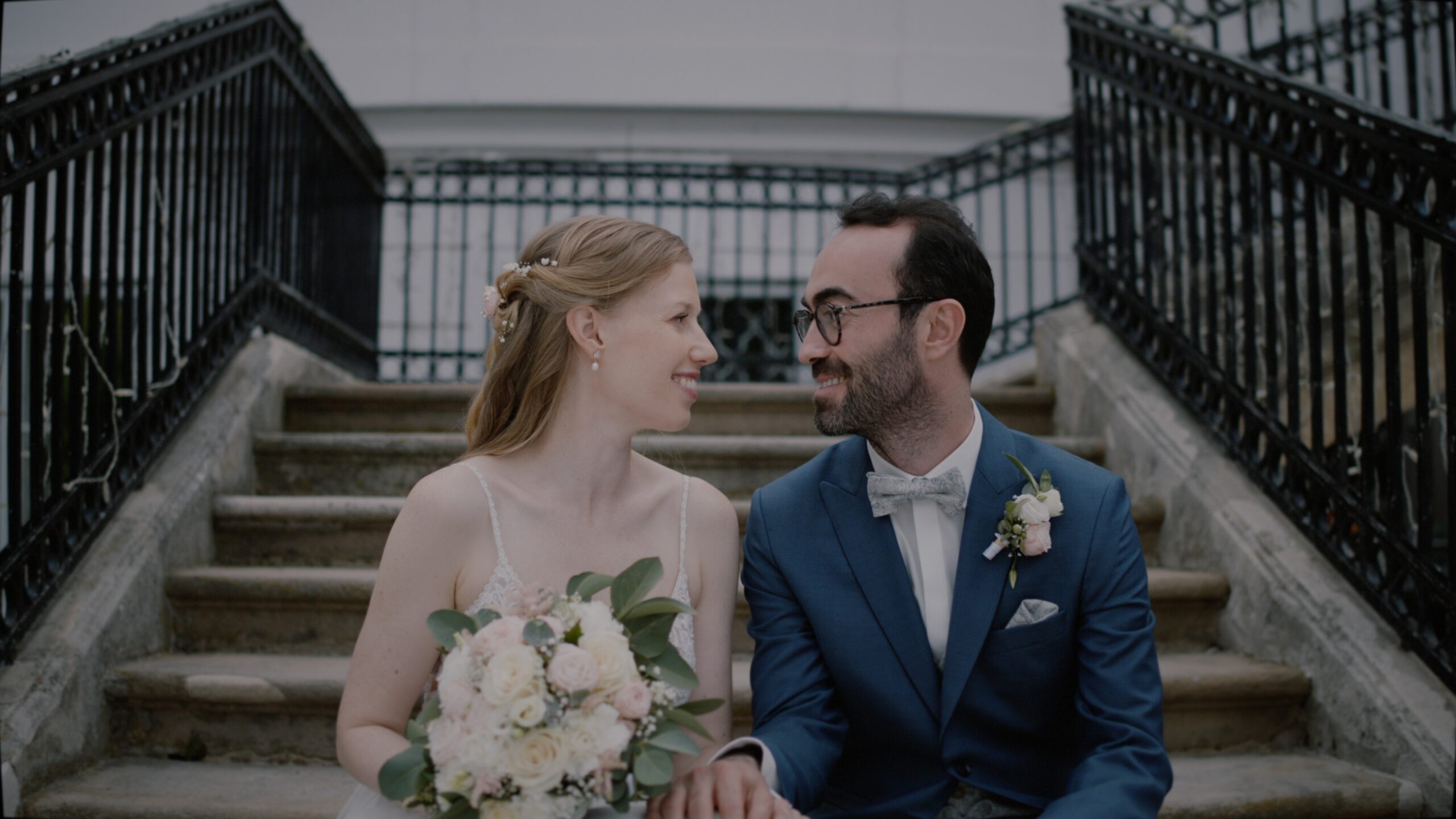 Verena and Ali standing on the garden path of Schloss Miller von Aichholz during their Vienna wedding.